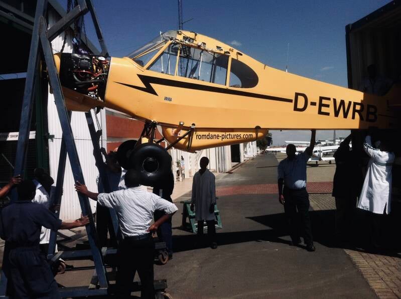 Marcel romdane’s Super Cub D-EWRB being unloaded at AMREF workshop, Nairobi, 2012 — bush-flying chaos begins. From Riches To Rags, an african odyssey 