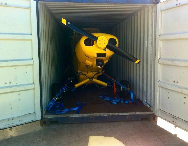Inside the Nairobi container: the yellow Super Cub, strapped down like a war criminal awaiting trial—Kalli’s mechanical wizardry keeping it so secure it could’ve survived re-entry, volcanic baptism, and three UN inspections without a scratch.