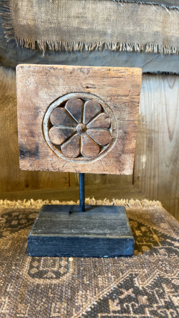 Oud houten ornament op metalen standaard