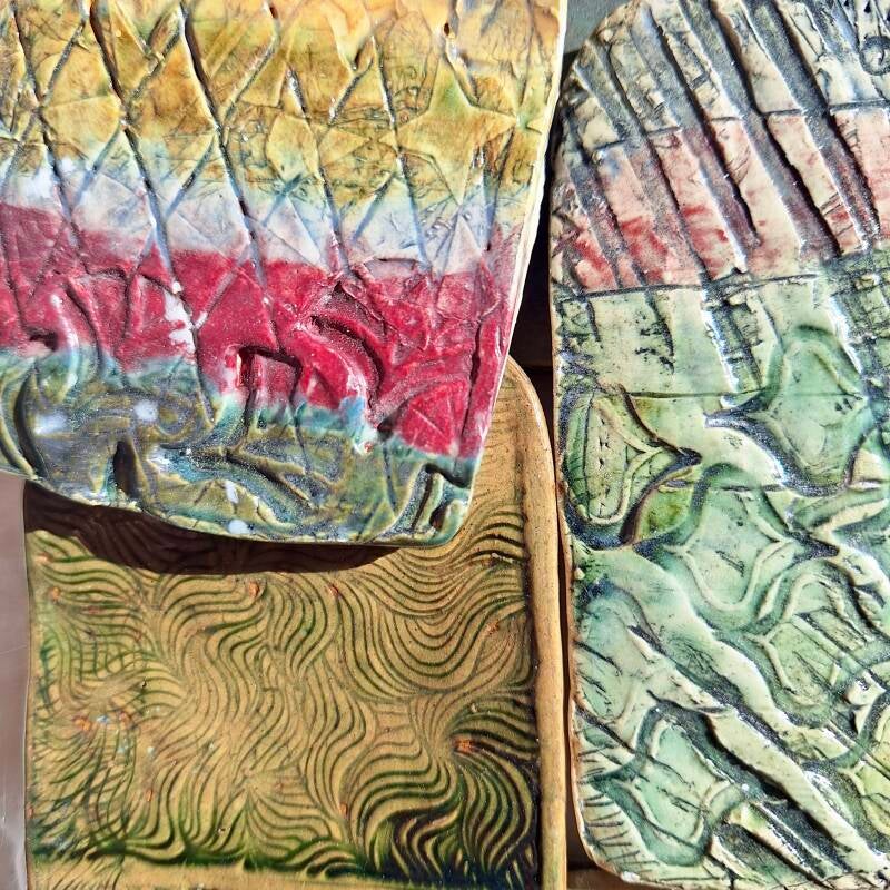 test tiles using a mix of underglaze stamps and household mesh