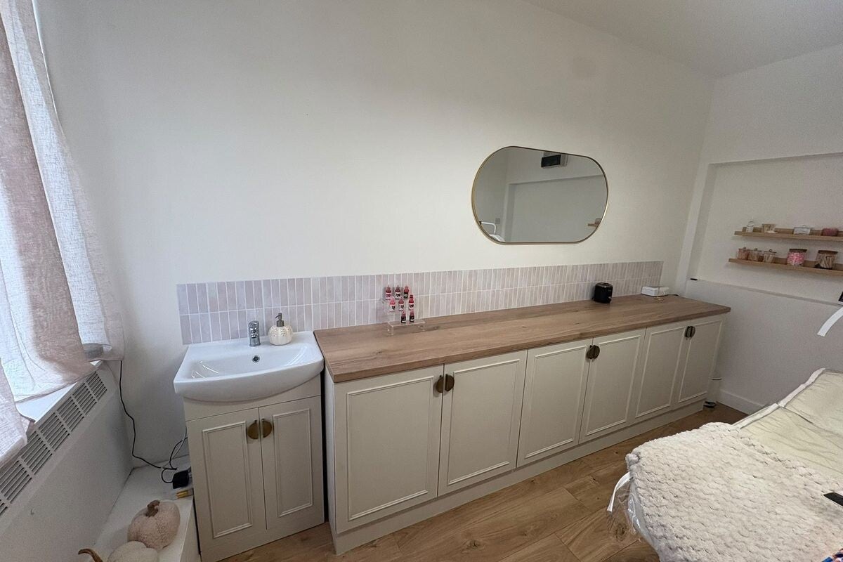 Bespoke treatment room fit-out with panelling and fitted units