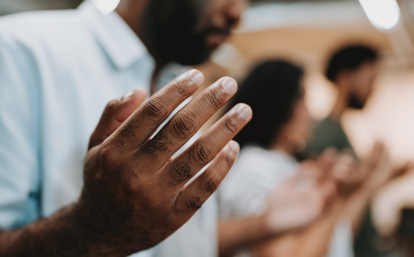 Hands lifted in worship and prayer during church service