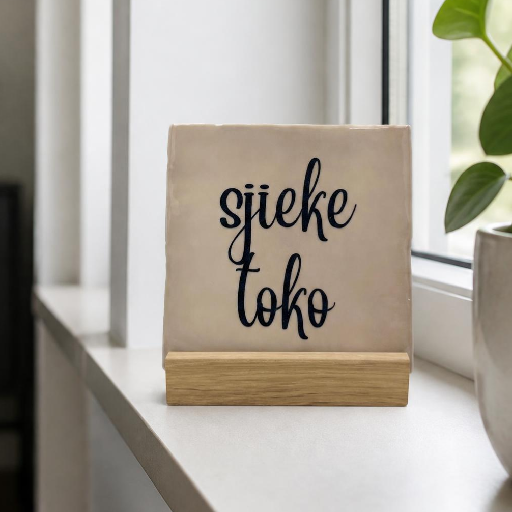 Niets is zo leuk als tegeltjes met een spreuk. Op de foto een tegeltje met de tekst Sjieke Toko
