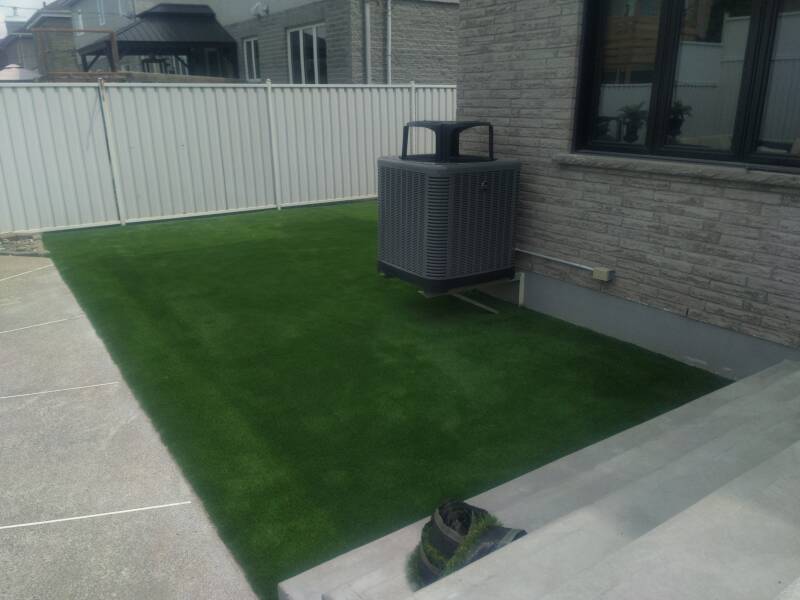 Artificial grass installed in backyard of home in Laval, Quebec