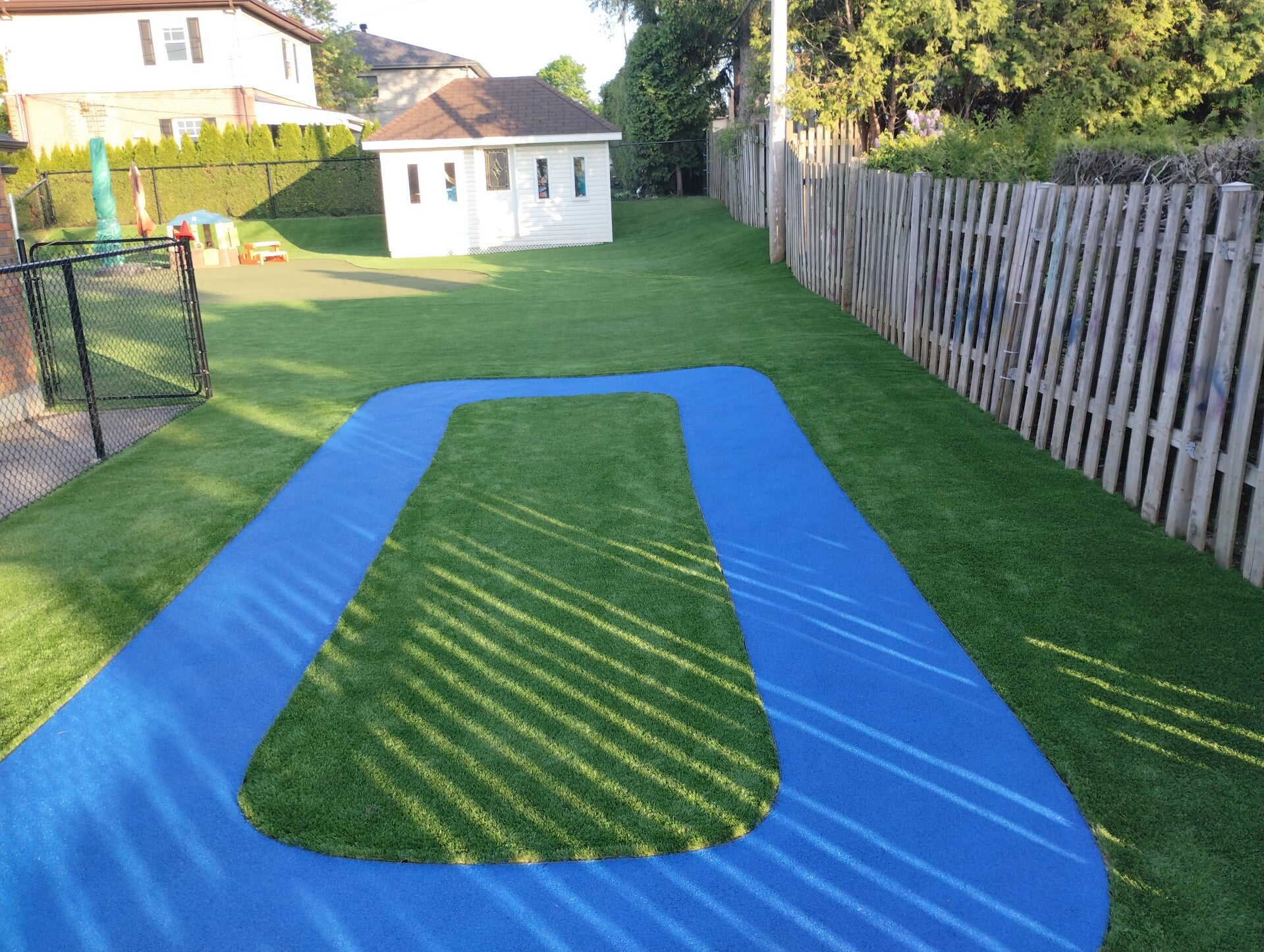 Installation of artificial grass combined with rubber pour-in-place surfacing at a CPE daycare in Dorval, Quebec