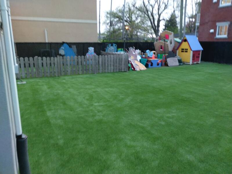 Artificial grass with rubber safety surface installed at playground in Montreal, Quebec – Capo Surface
