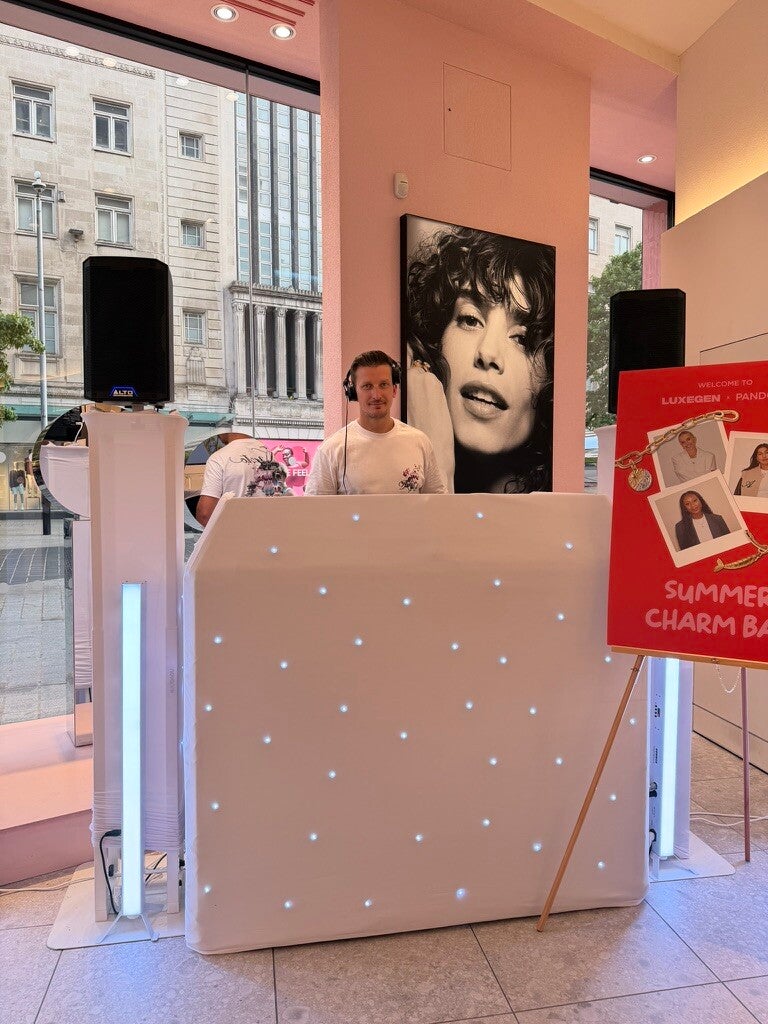 Matt Hall DJing behind the white MHX booth at a Pandora brand event
