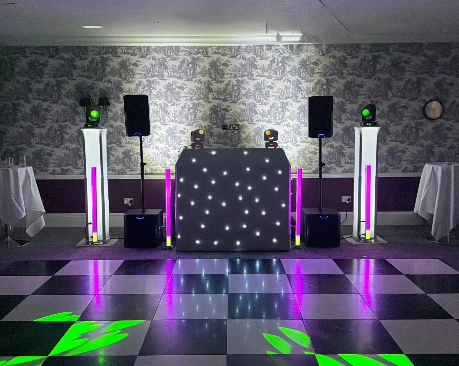Black MHX wedding DJ booth, lighting and speakers in a reception room