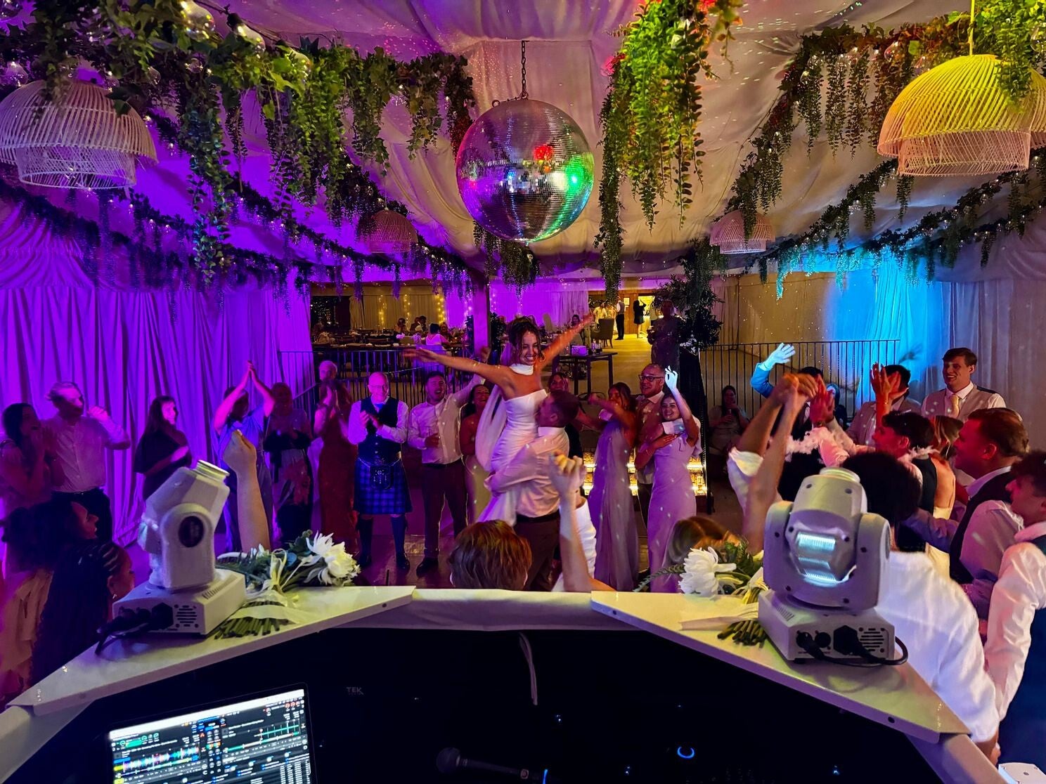 Bride lifted above the dancefloor by a guest at a Crockwell Farm wedding