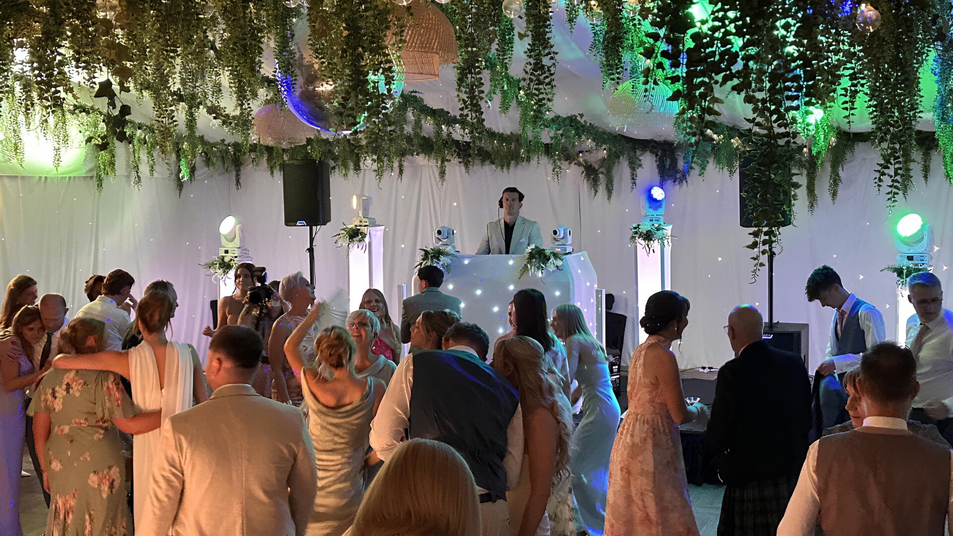 Wedding guests dancing around an MHX DJ at a reception