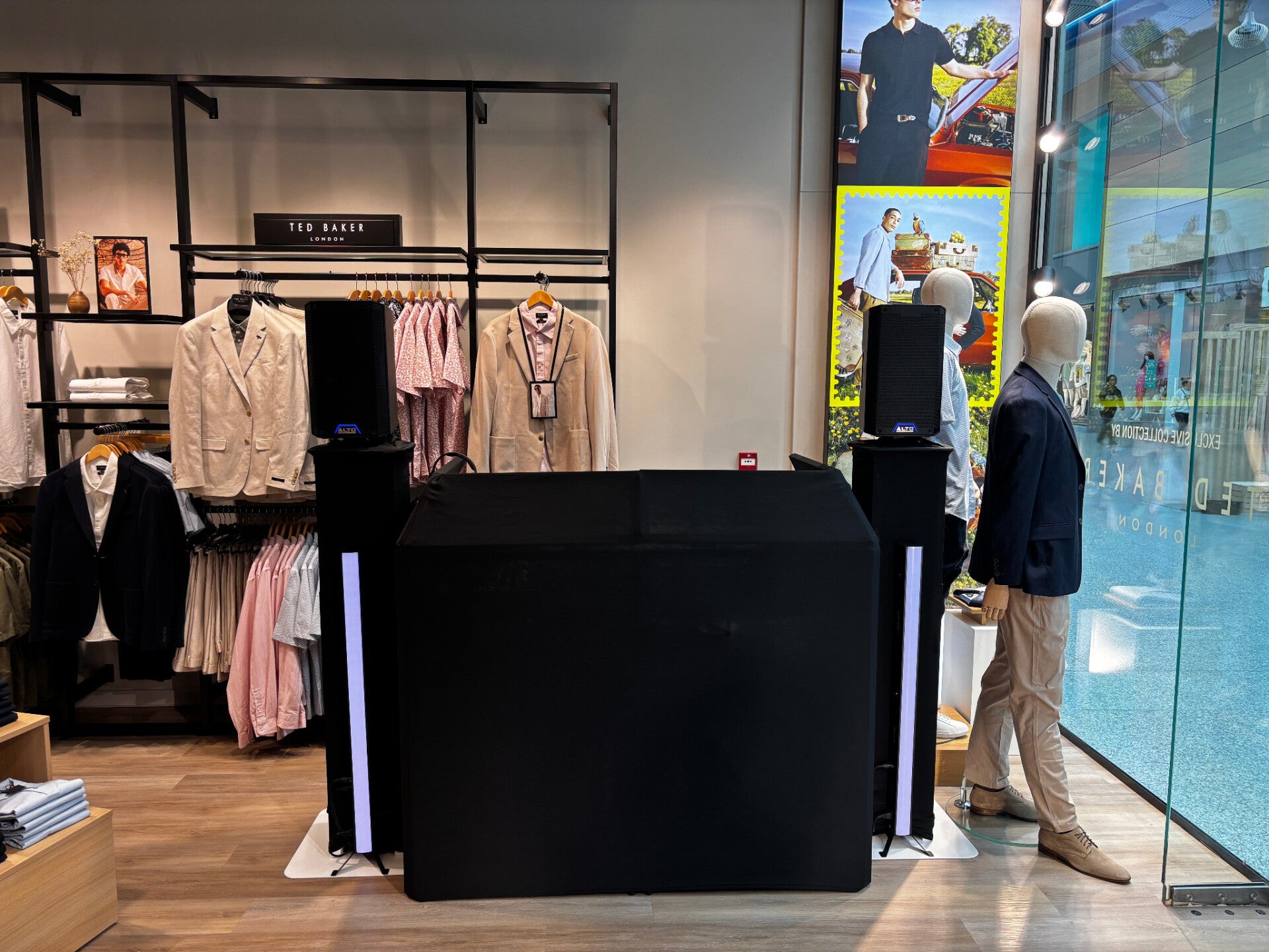 Compact black MHX DJ booth inside Suit Direct