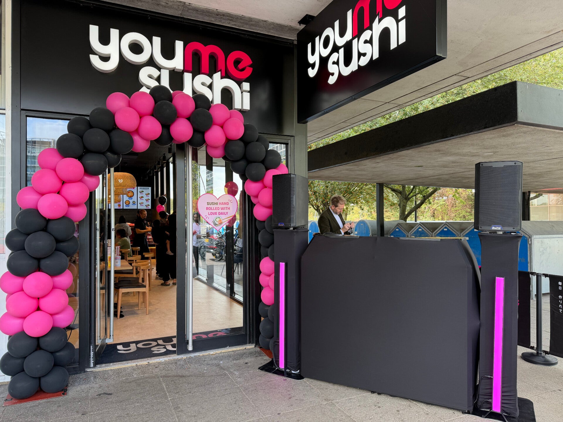 Black MHX DJ booth with pink light bars outside YouMeSushi