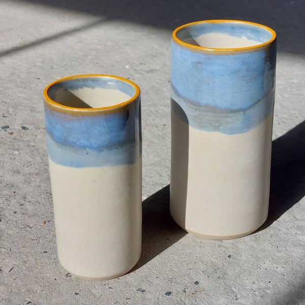 Vaas midden in witte klei met mat, blauw, gele glazuur