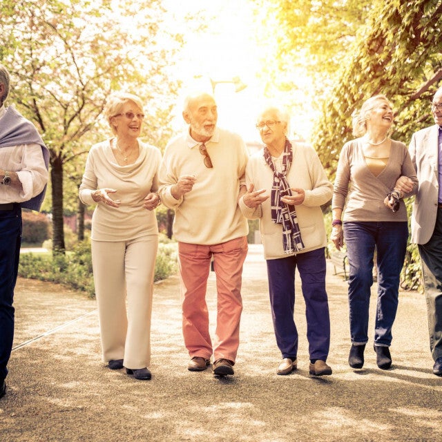 Happy senior tourists walking together showcasing reliable elderly taxi transfer service by Taxi Jakovina Biograd na Moru