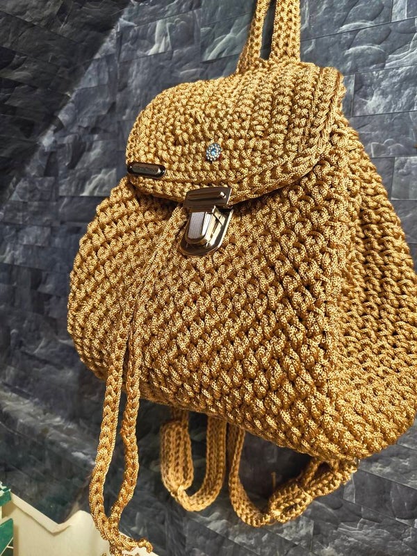 Brown backpack with leather bottom and silver harduare.