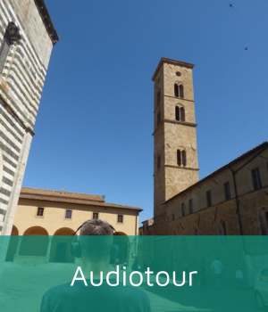 Man with headphones walking in the center of Volterra.