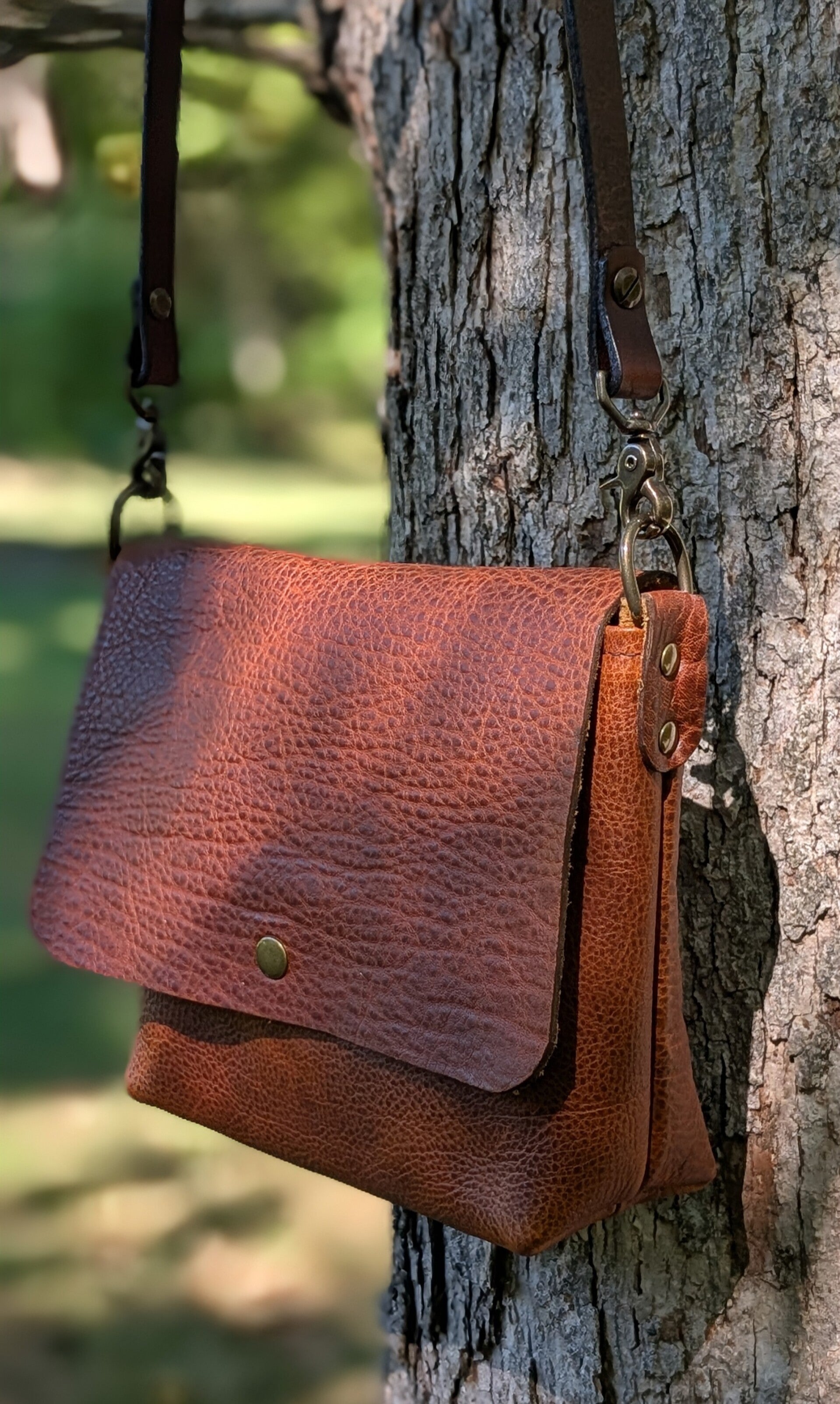 Leather cross body bag with flap closure