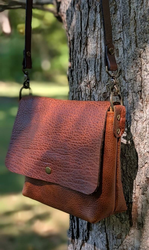 Leather cross body bag with flap closure