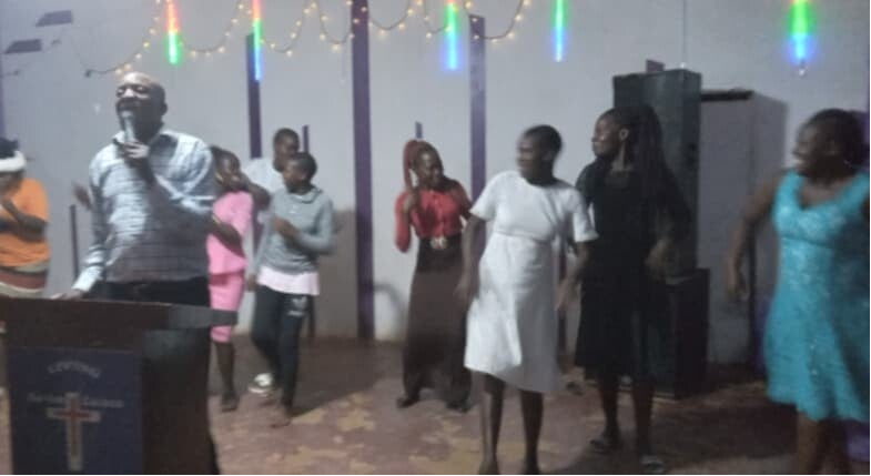Members of small church in Uganda sing at church.