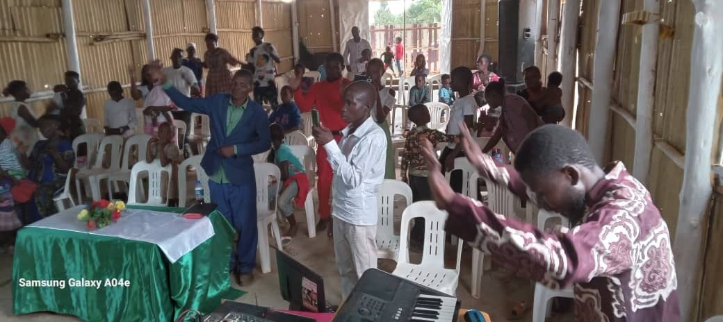 Members of a small African Church in Uganda worship and sing songs