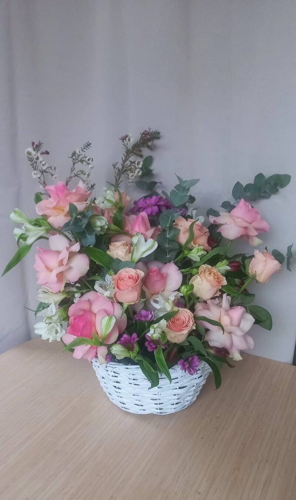 Arangement met Rozen in mandje.