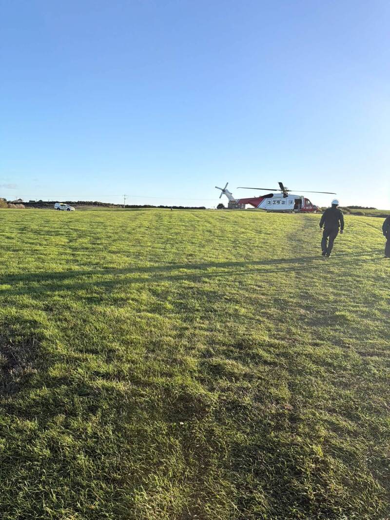 Coastguard helicopter and RNLI lifeboat during multi‑agency rescue at Thornwick Bay