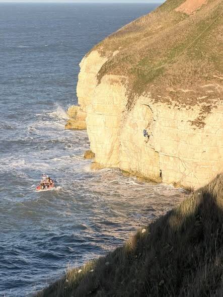 Coastguard helicopter and RNLI lifeboat during multi‑agency rescue at Thornwick Bay