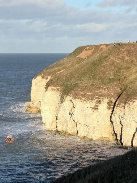 Coastguard helicopter and RNLI lifeboat during multi‑agency rescue at Thornwick Bay