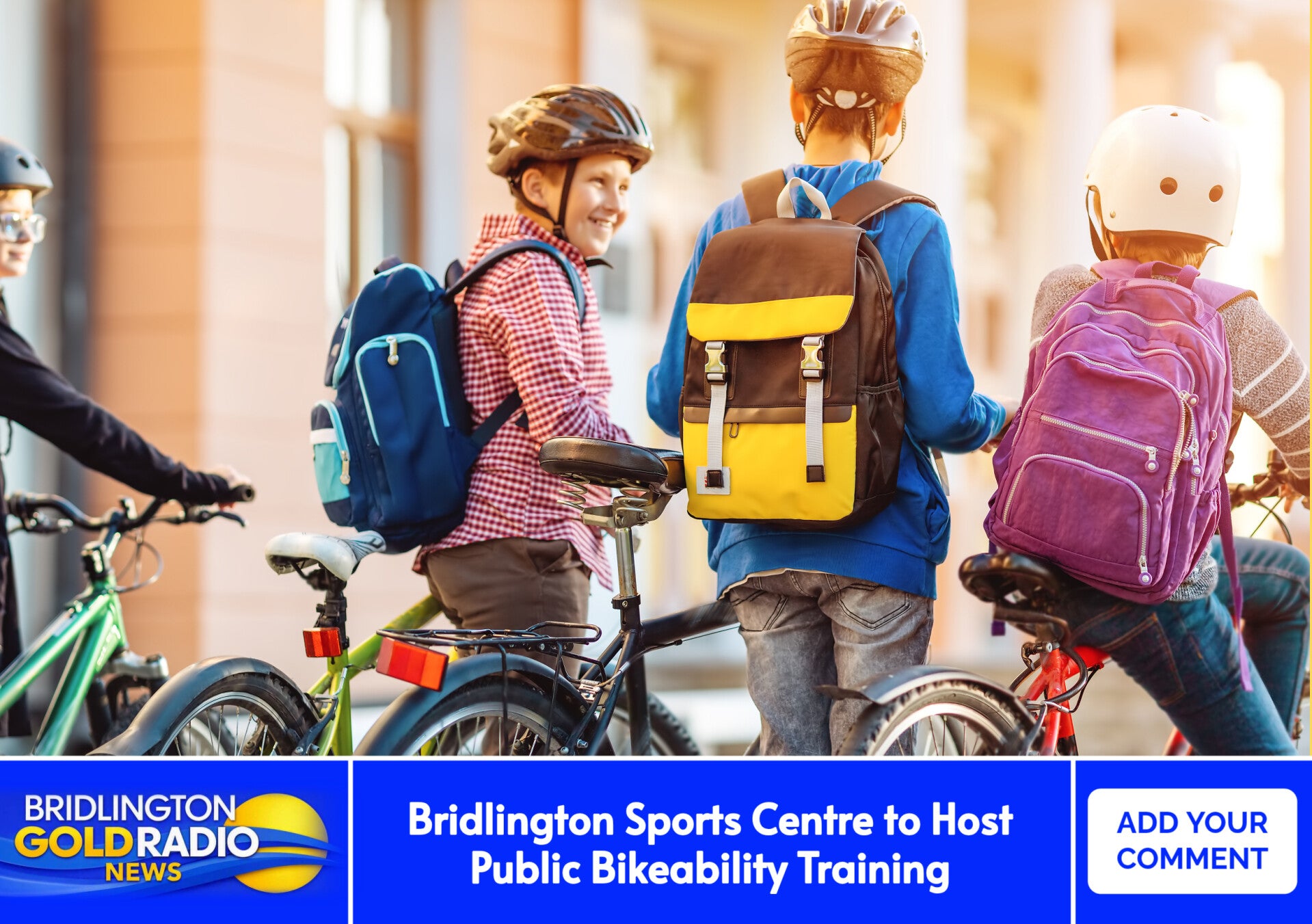 Children wearing helmets and colourful backpacks stand beside their bicycles outside a building, smiling and chatting in warm sunlight — representing safe, confident young cyclists preparing for a ride.