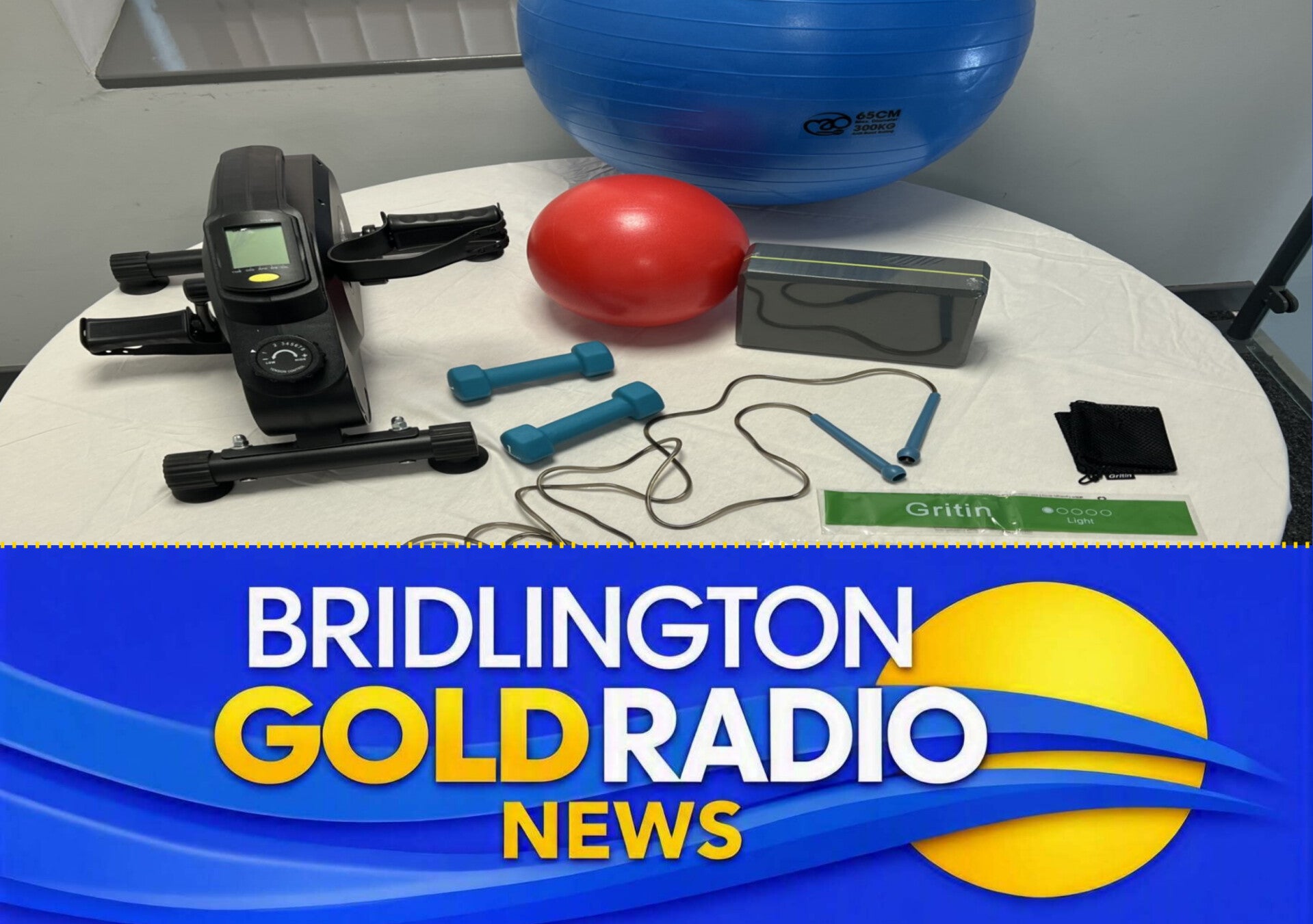 Bridlington Mobile Library staff showcasing Gym in a Box equipment including exercise balls, dumbbells and resistance bands