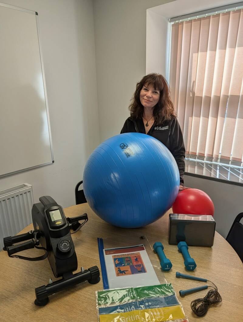 Bridlington Mobile Library staff showcasing Gym in a Box equipment including exercise balls, dumbbells and resistance bands