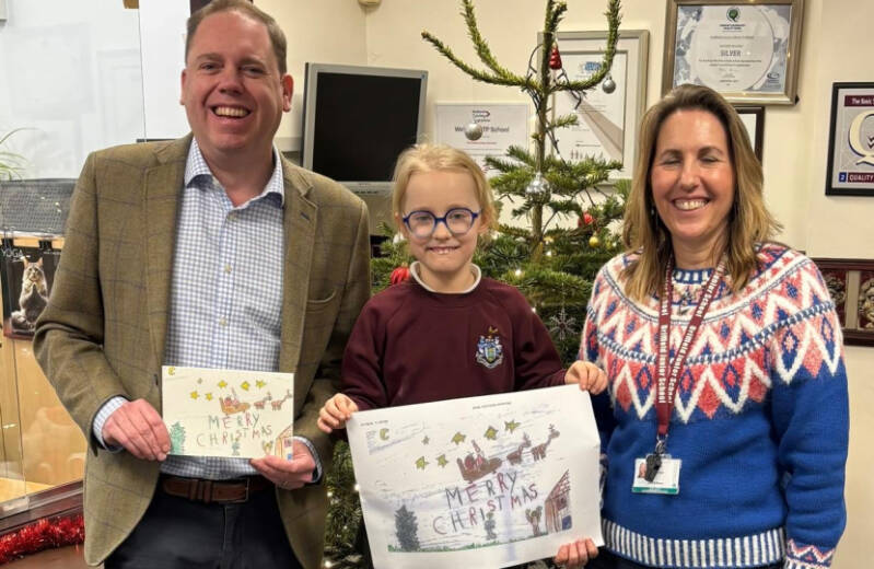 Charlie Dewhirst MP with local primary school pupils showcasing their Christmas card designs