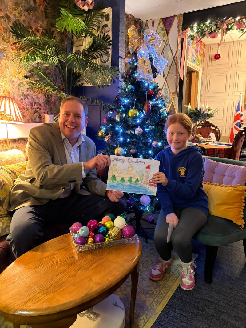 Charlie Dewhirst MP with local primary school pupils showcasing their Christmas card designs