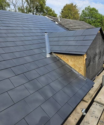 Slate repair - salisbury roof - new roof - roofing materials - great asthetic - neat black slate roof - new roof with warrenty - roofer - rubber seal - guttering