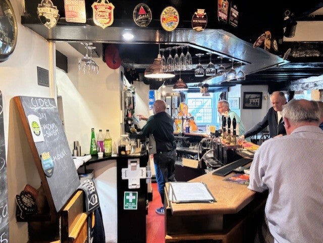 Geoff in action behing the bar at The White Hart Cross