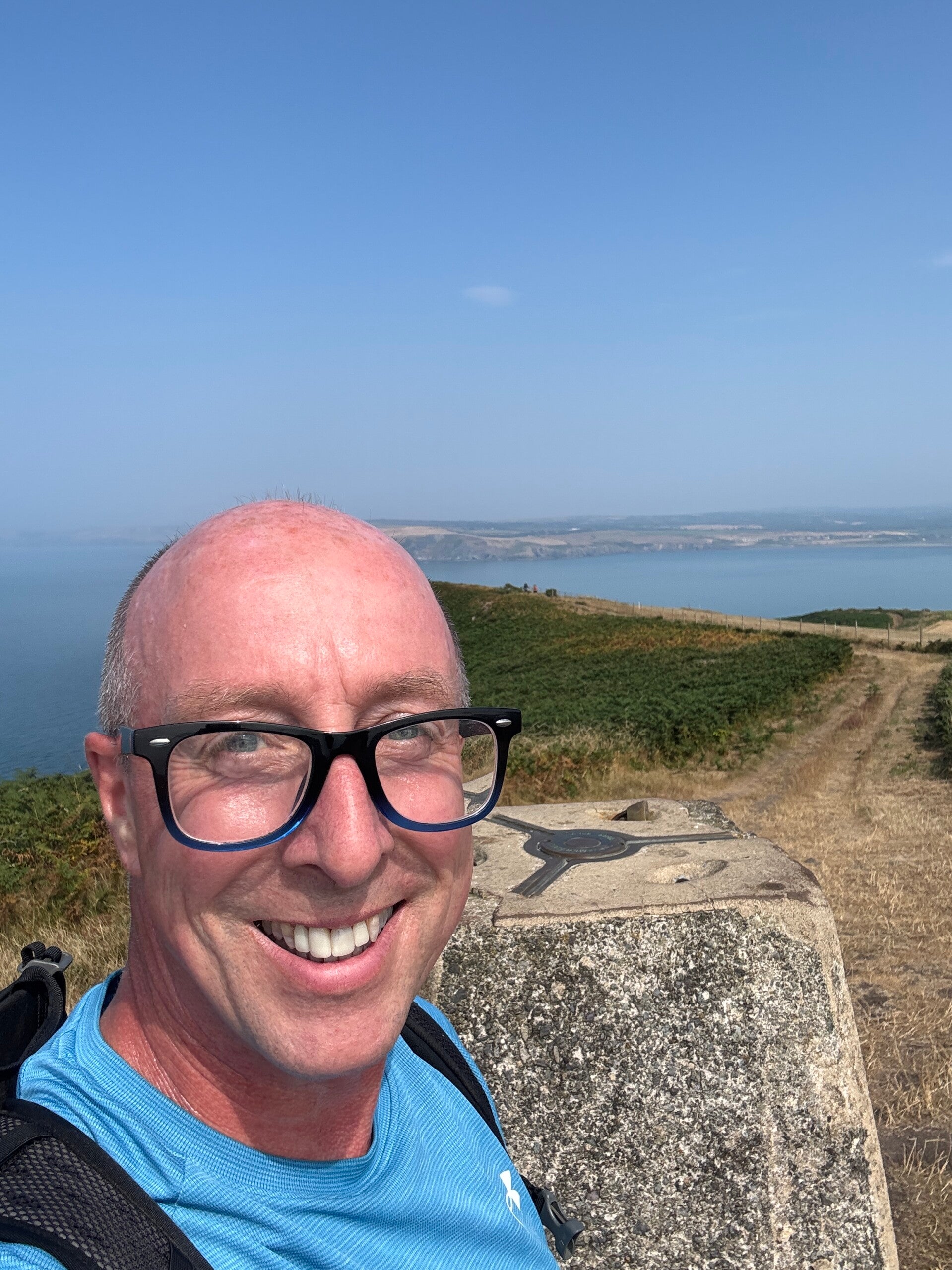 Richard Pinnington at the trig point on Dinas Head
