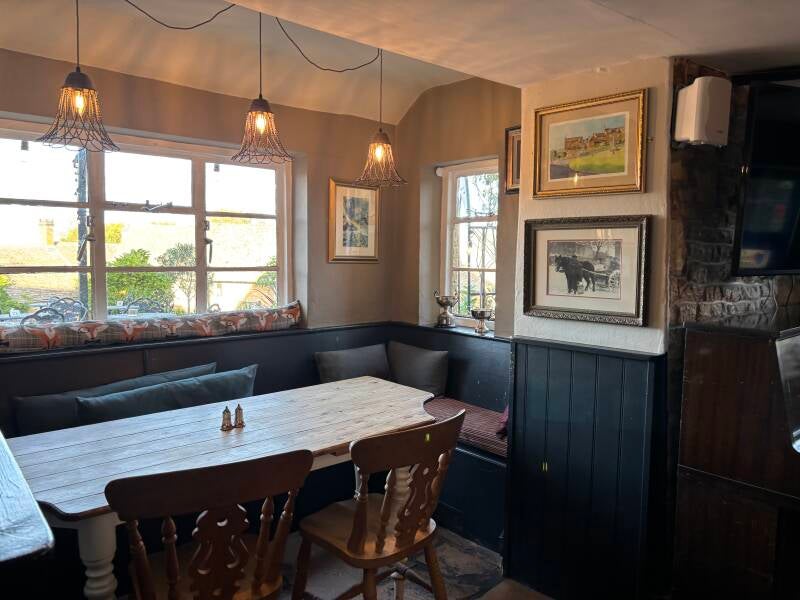 Seats in the bay window at The Coach & Horses in Longborough