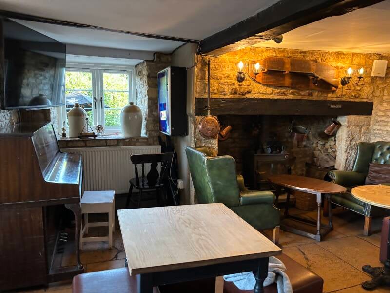 Piano and fireplace at Coach & Horses in Longborough