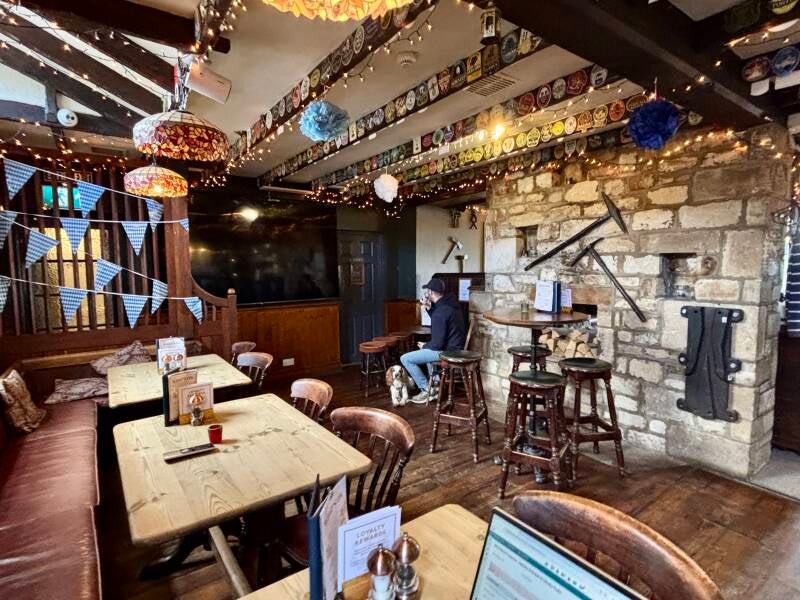 Seating and a big screen at The Quarrymans Arms at Box Hill