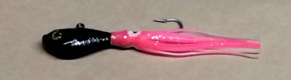 boat jig 55 gms speckled black with squid skirt eye colour will vary
