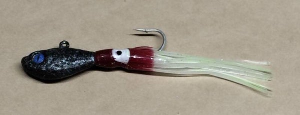boat jig 55gms speckled charoal with squid skirt eye colour will vary