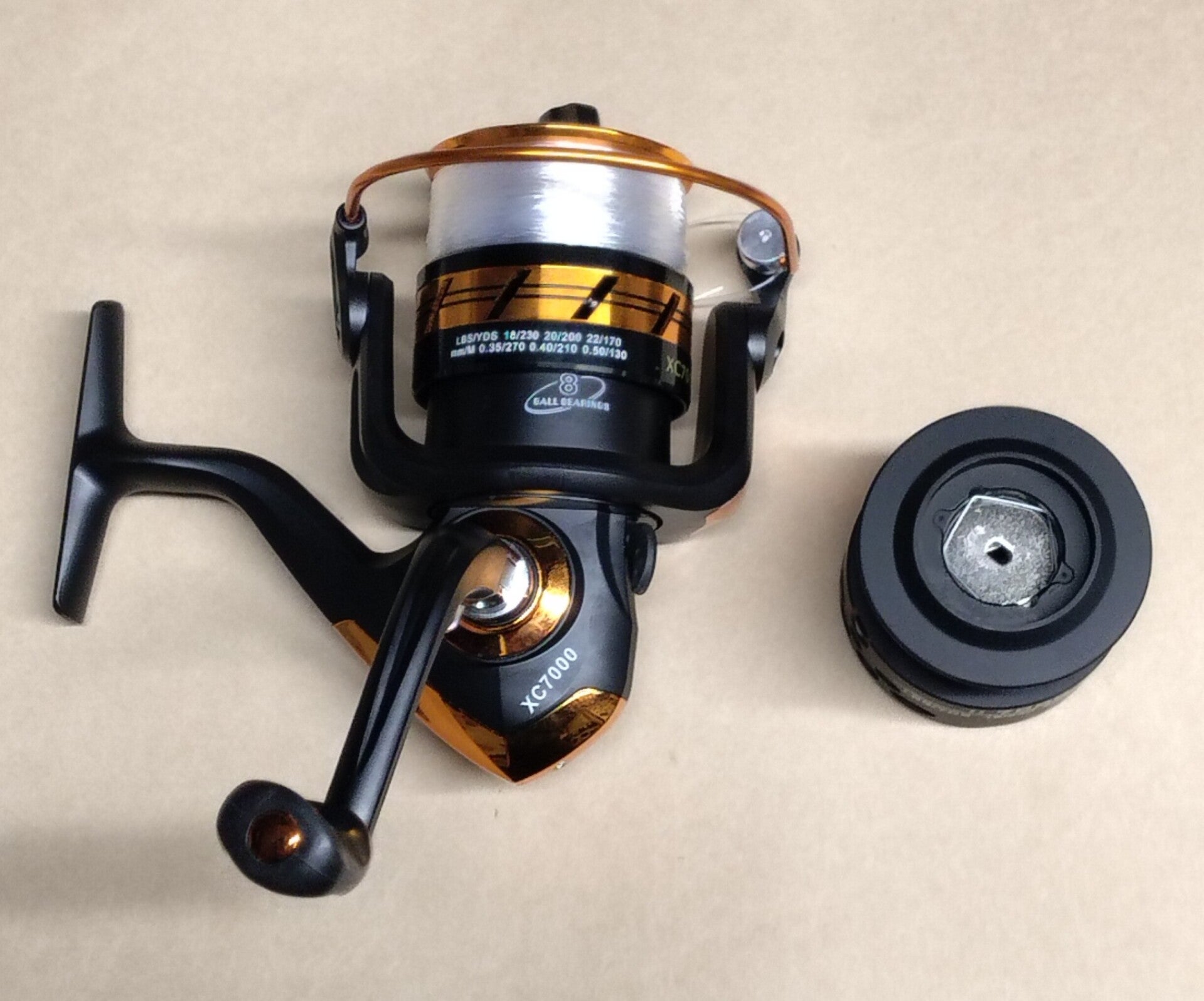 Light surfcasting reel ( new) xc7000 reel loaded with line and spare spool