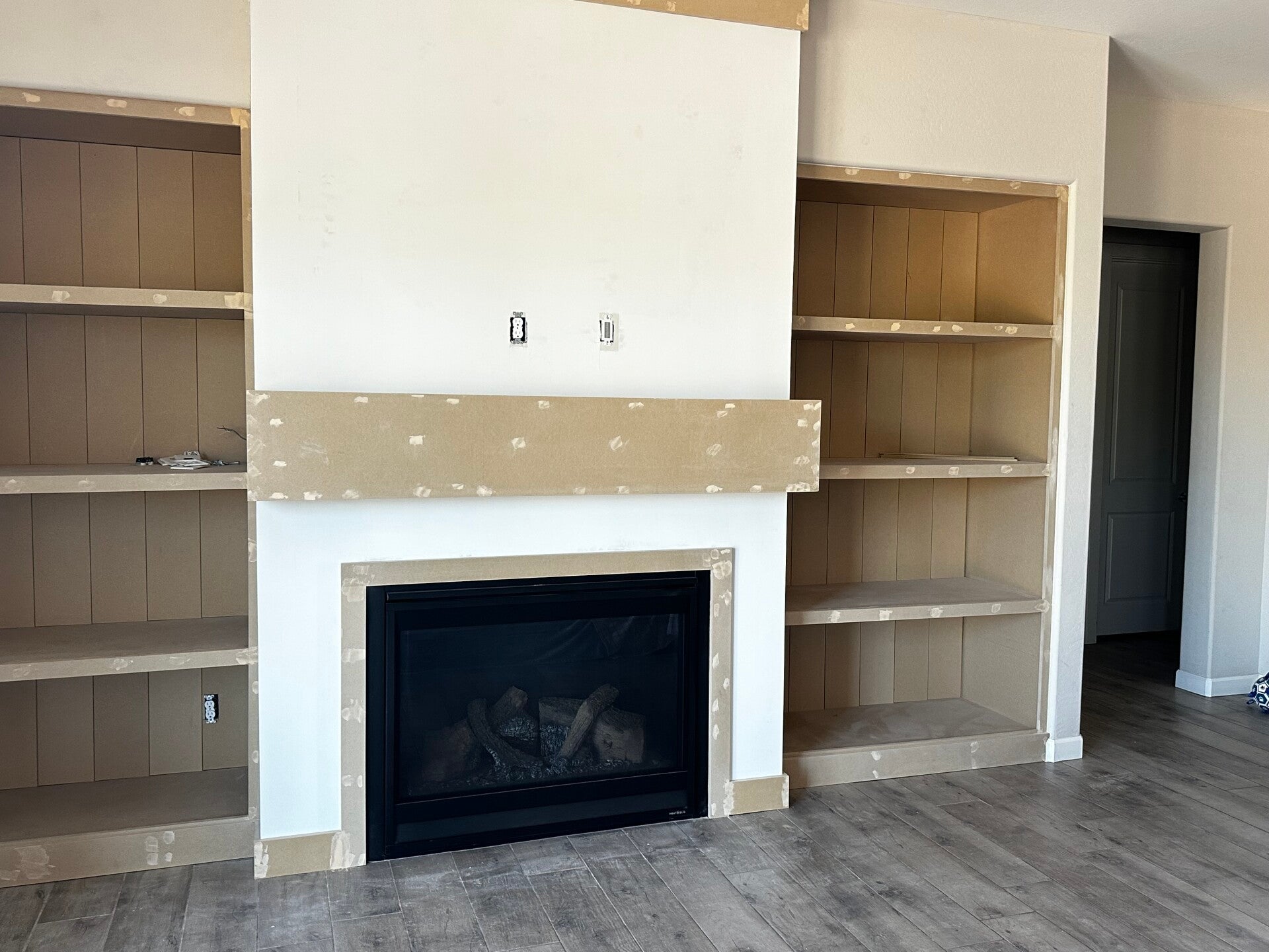 in progress fireplace remodel with shiplap and shelves