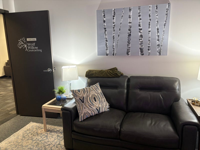 Cozy Office Space With A Sofa, Armchair, Desk With A Computer, And Window Light