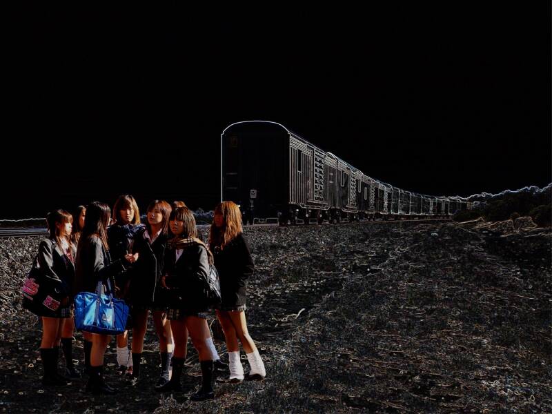 japanse schoolmeisje in onherbergzaam landschap en goederentrein (photoshop)