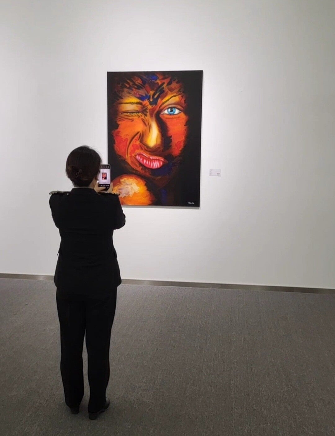 A visitor viewing a portrait painting by Willem Vos at Hong Art Museum.