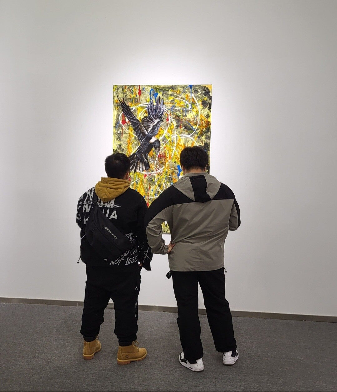 Two visitors studying a bird painting by Willem Vos during the Chongqing exhibition.