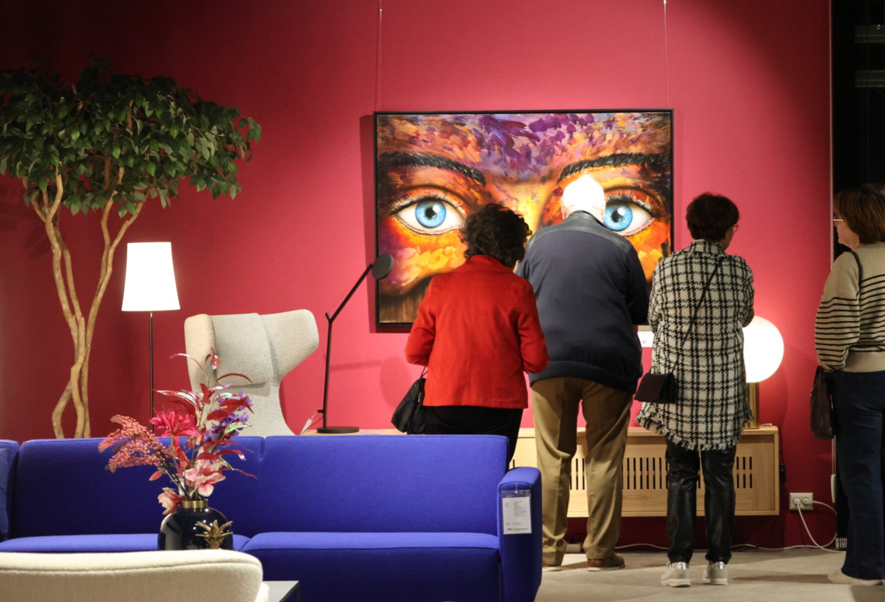 Visitors viewing a large painting by Willem Vos during an exhibition in Dwingeloo, the Netherlands.