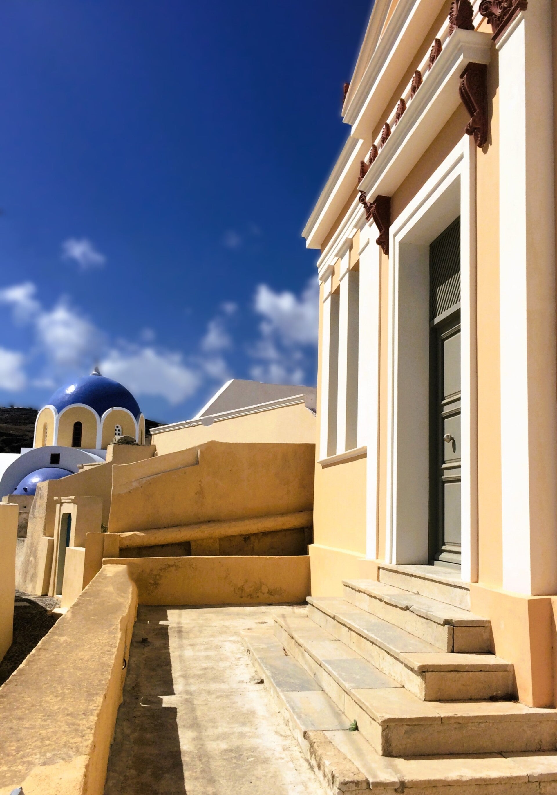 Vothonas village. Council building and a blue domed church in the background