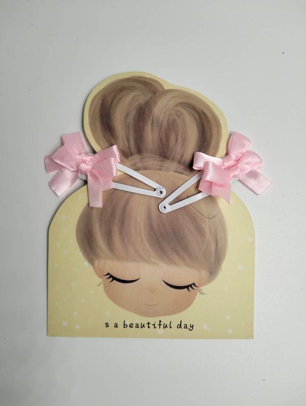 Haar speldjes 'strikjes pink'